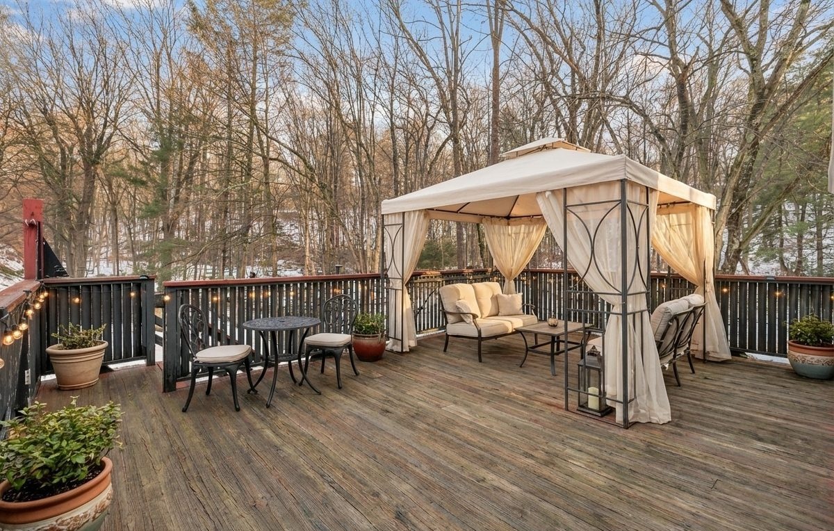 Deck staged with gazebo and outdoor furniture