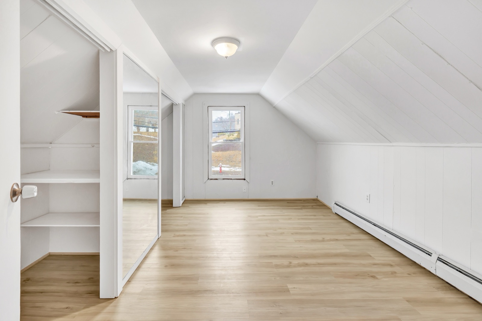 Empty Naugatuck CT upstairs bedroom with sloped ceiling before virtual staging