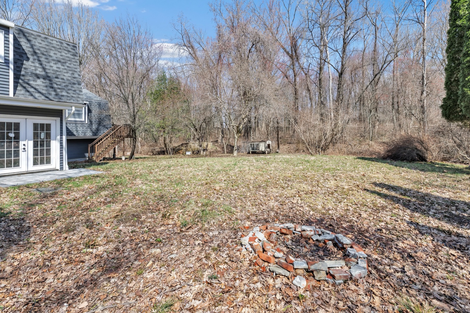 Empty New Milford CT backyard fire pit area before virtual staging