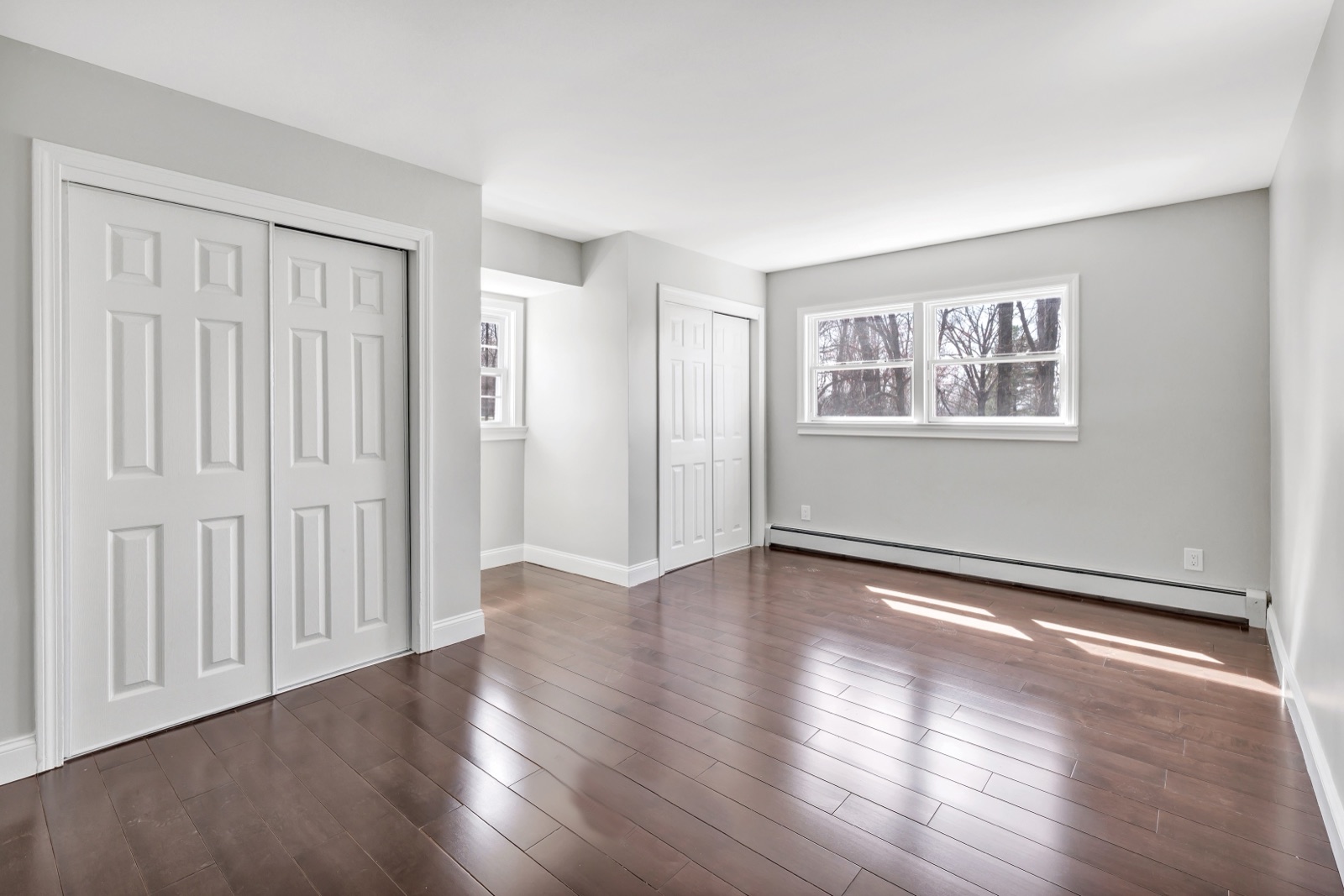 Empty New Milford CT top-floor secondary bedroom before virtual staging