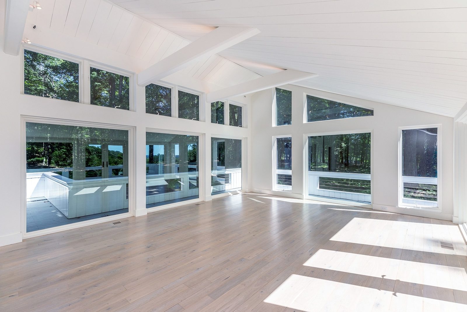 Washington CT family room, glass corner before virtual staging